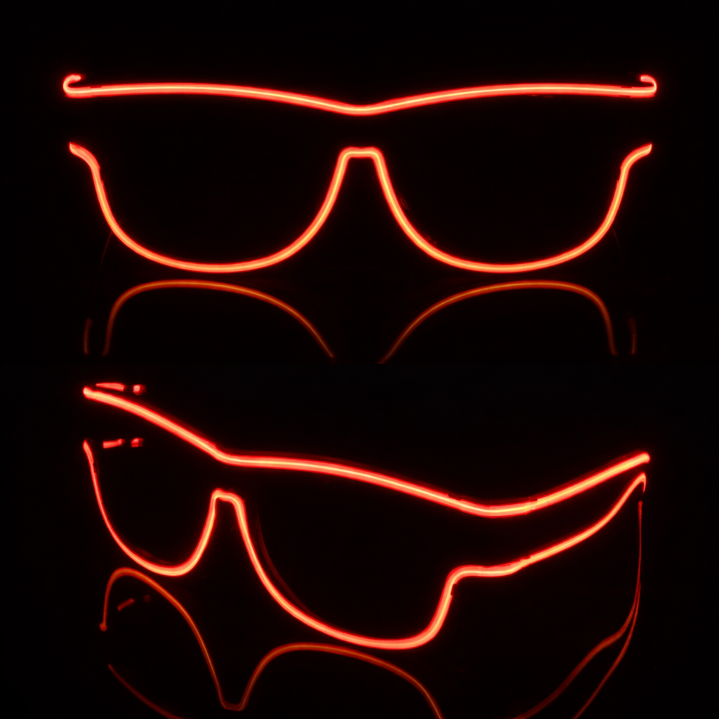 Neon orange sunglasses on a black background
