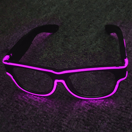 Black sunglasses with pink LED lights on a dark textured surface